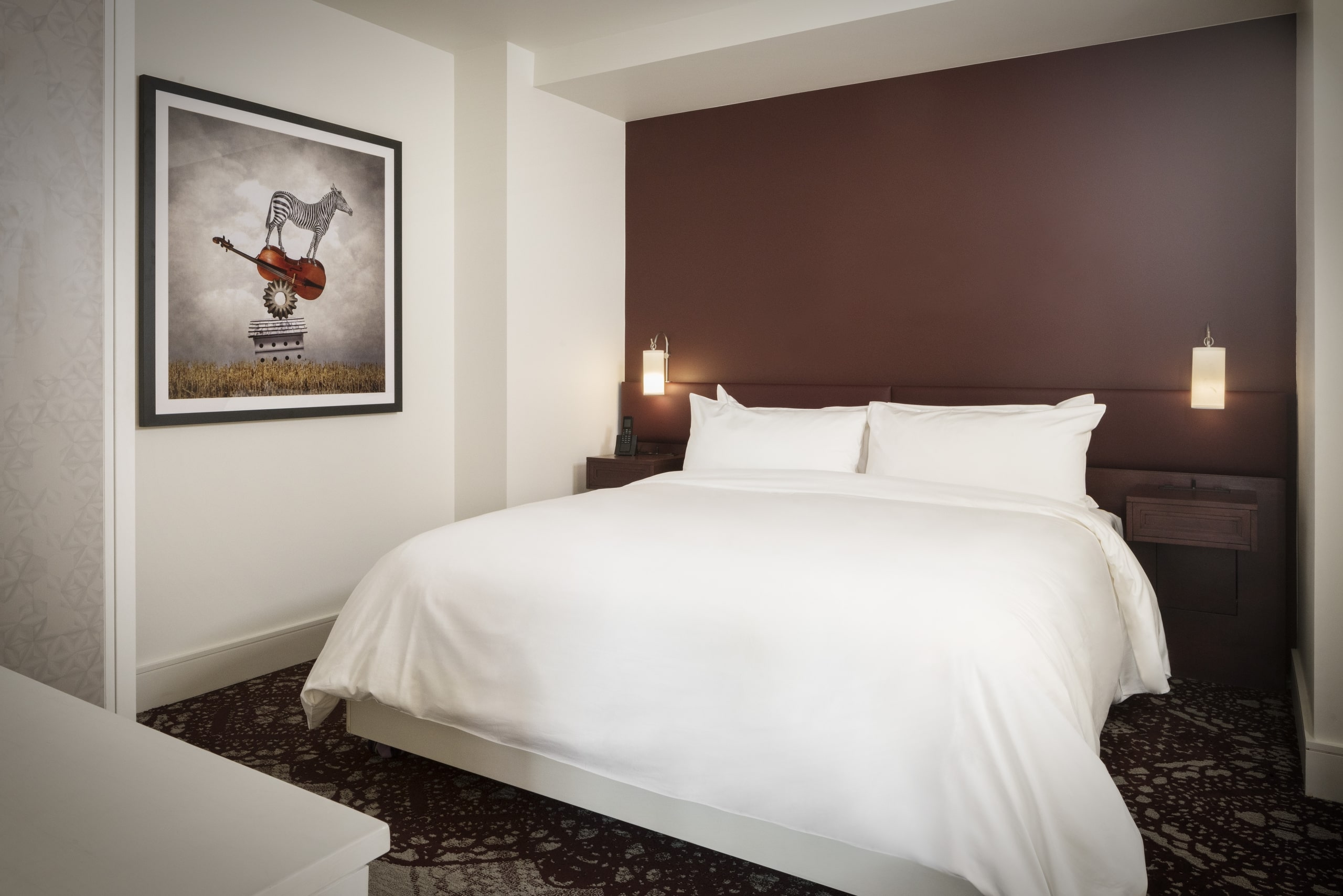 Corner King Room at The Elizabeth Colorado with a large bed and painting on the wall