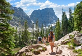 Family hiking on summer vacation in Colorado mountains.