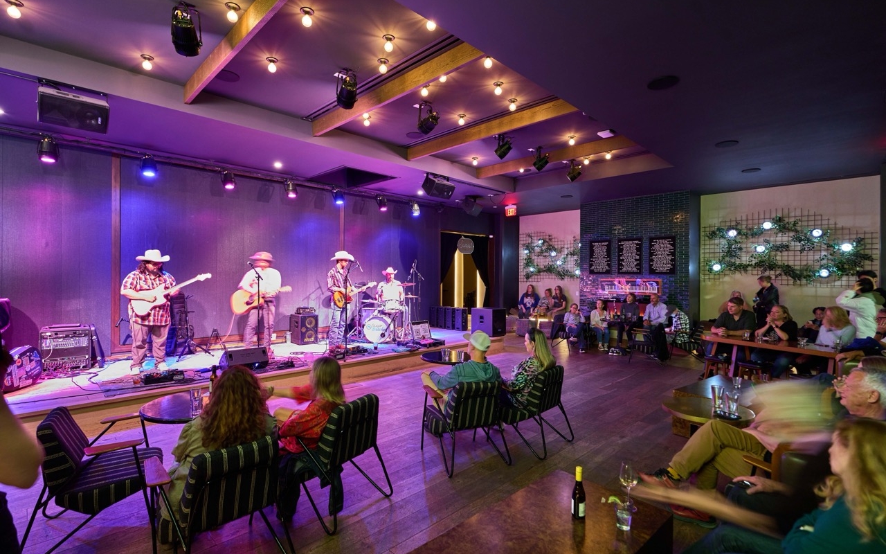 People seated watching a performance at Magic Rat