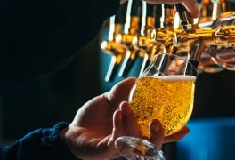 Close up of bartender pouring draft beer in glass