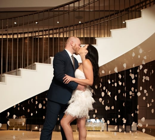couple kissing at the bottom of the stairs