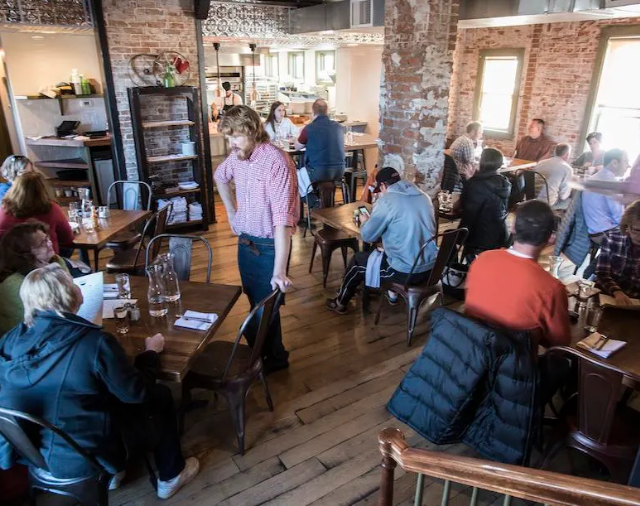 people in a cafe eating and ordering food in fort collins