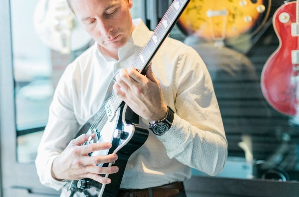 man playing a guitar at the hotel