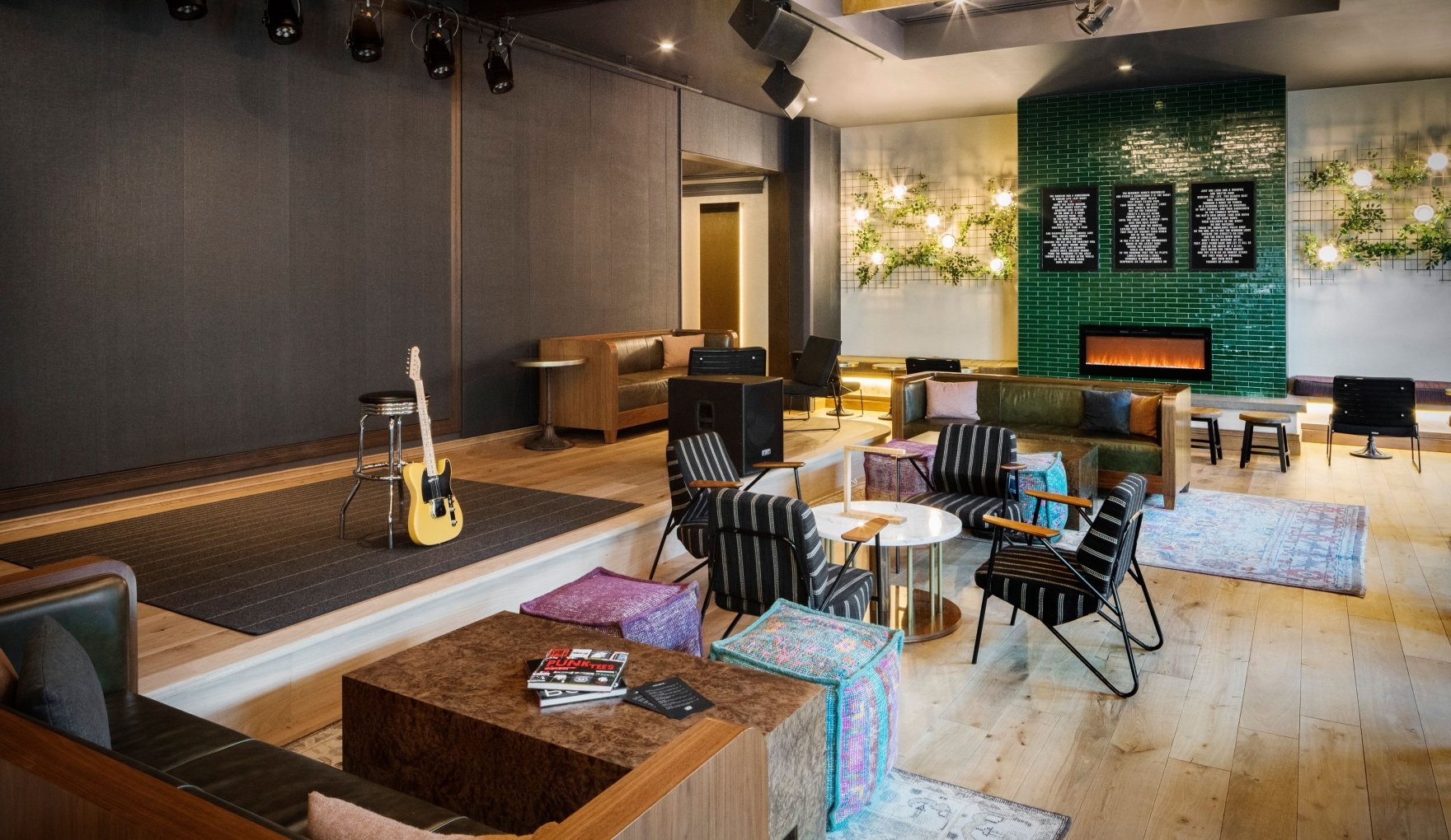 A guitar leaned up against a stool at the stage area of Magic Rat