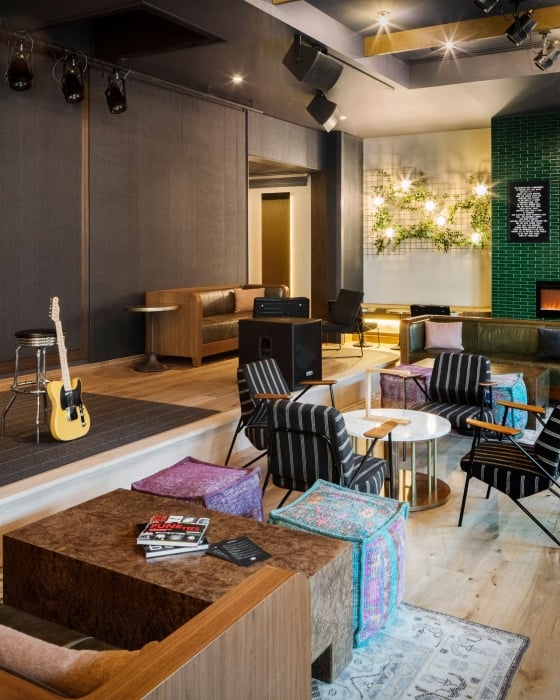 A guitar leaned up against a stool at the stage area of Magic Rat