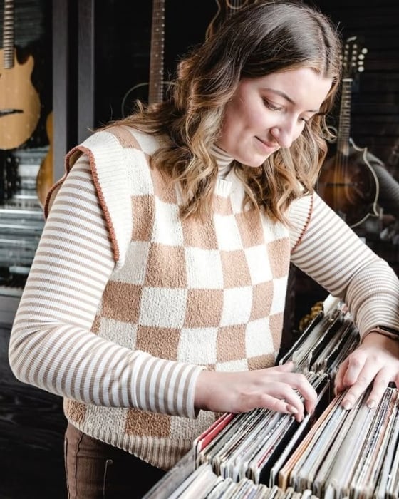 A woman looks through a crate of vinyl records at the Elizabeth Hotel