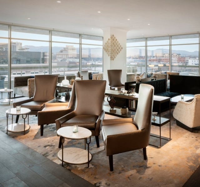 A comfortable seating area with high-backed lounging chairs at the Sunset Lounge