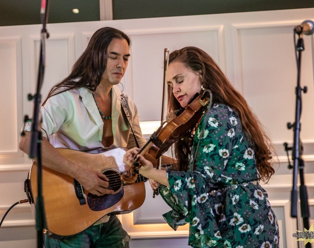A guitar and fiddle duo play at the Sunset Lounge