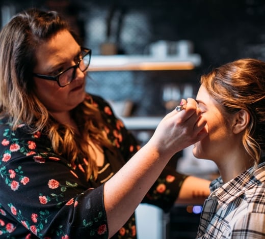 A bride getting her make up done before her wedding at the Elizabeth Hotel