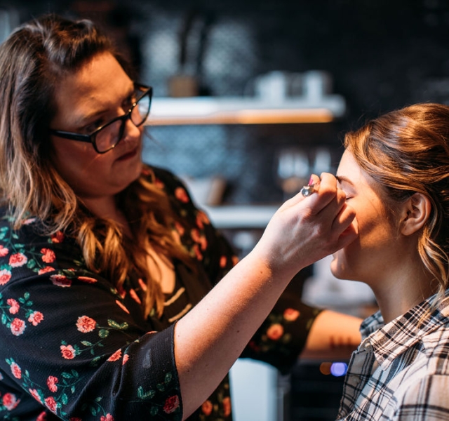 A bride getting her make up done before her wedding at the Elizabeth Hotel
