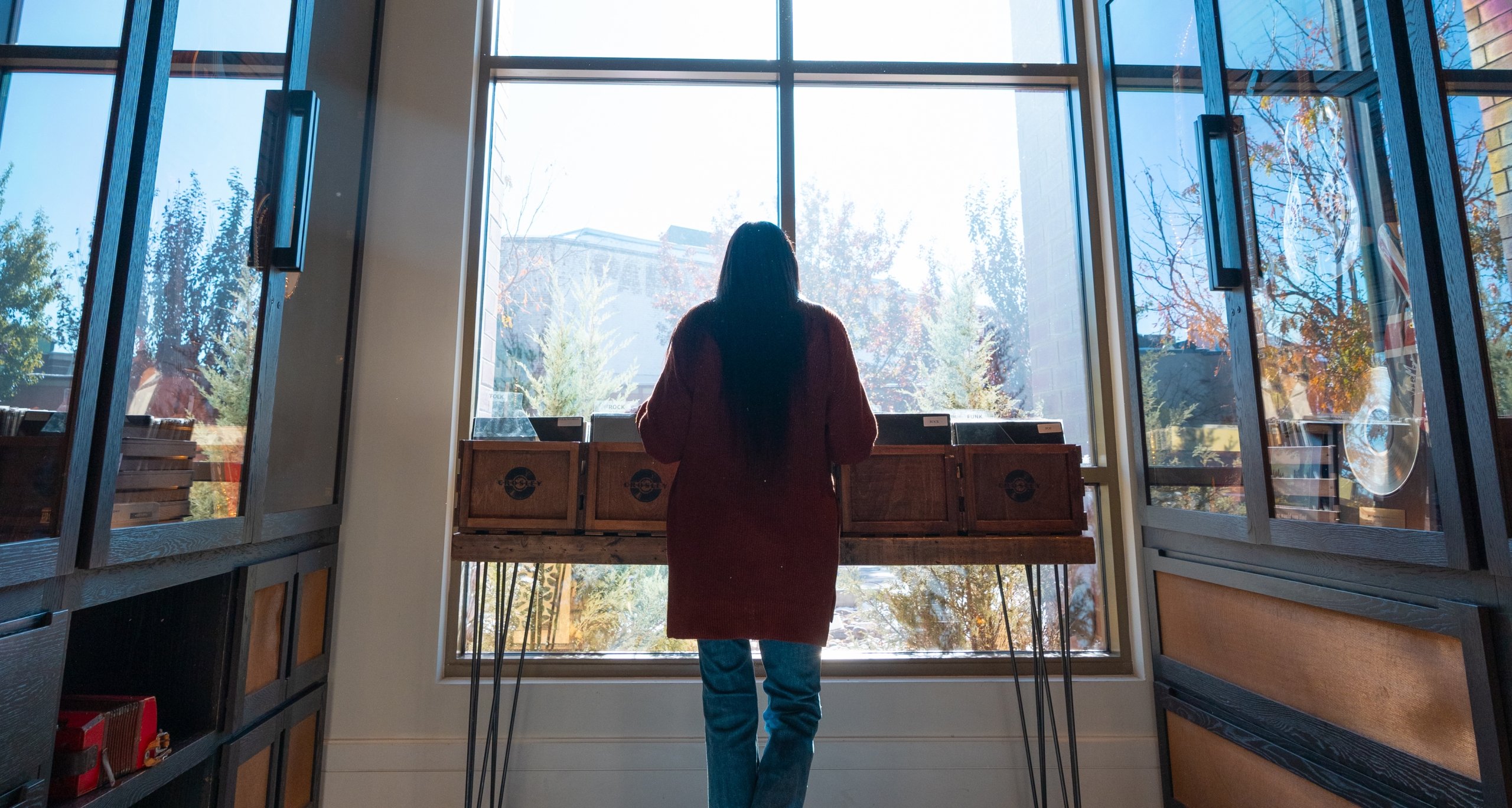 woman looking at the vinyl library at the hotel