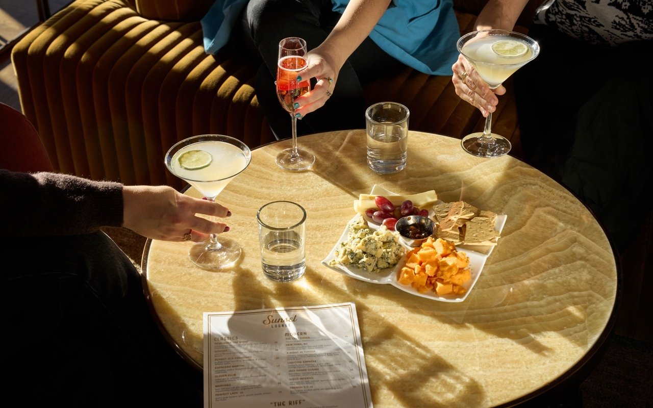 Assortment of beverages and charcuterie platter at The Sunset Lounge