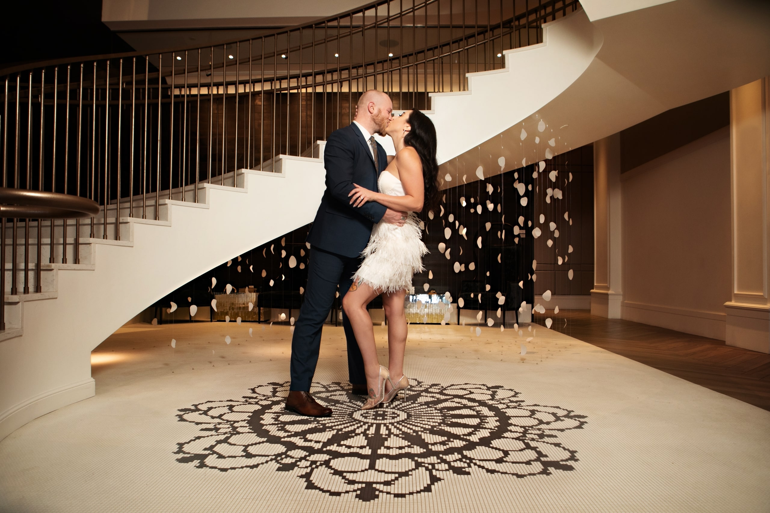 A couple kissing at the bottom of the stairs at The Elizabeth Colorado